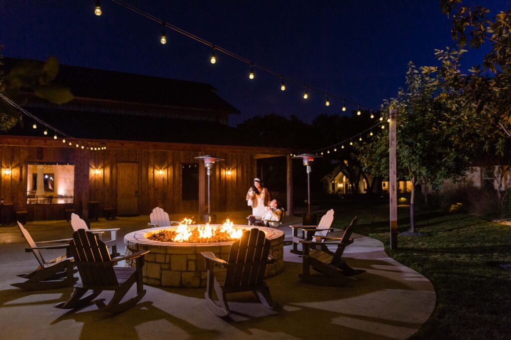 bride and groom making use of the venue's fire ring