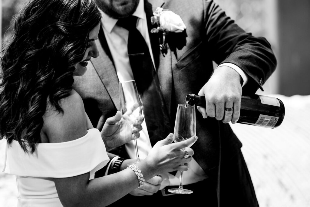 couple does their private champagne toast during their own elopement in south Austin