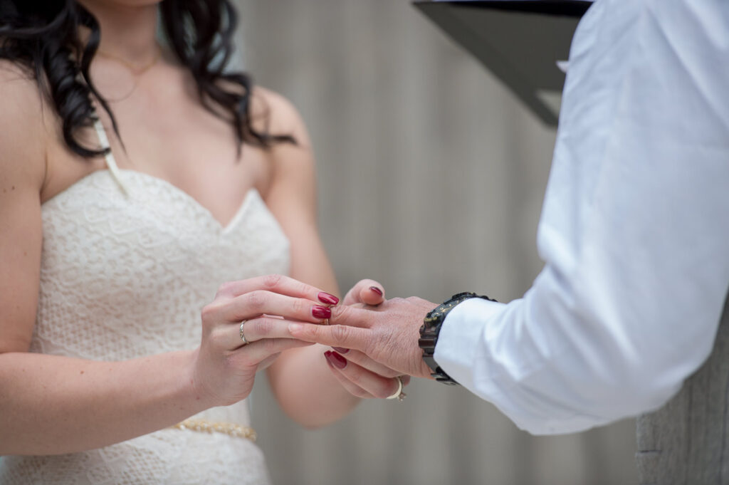 wedding ceremony ring exchange at firefly farm barn wedding