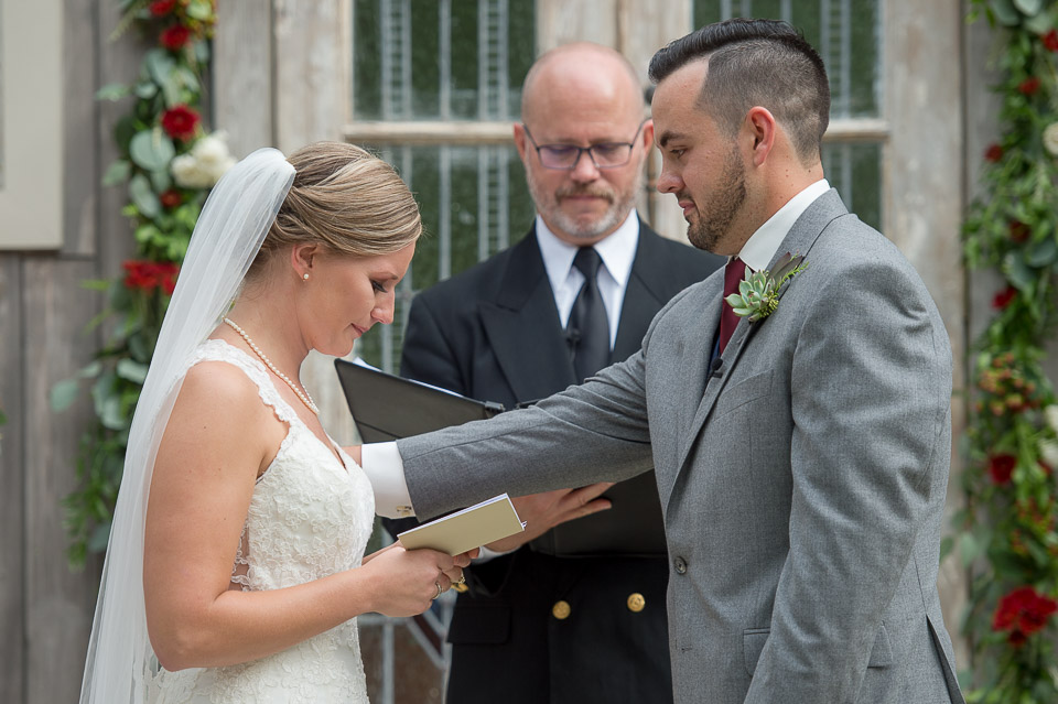 groom reassuring his bride as she recites her vows during their wedding ceremony at firefly farm