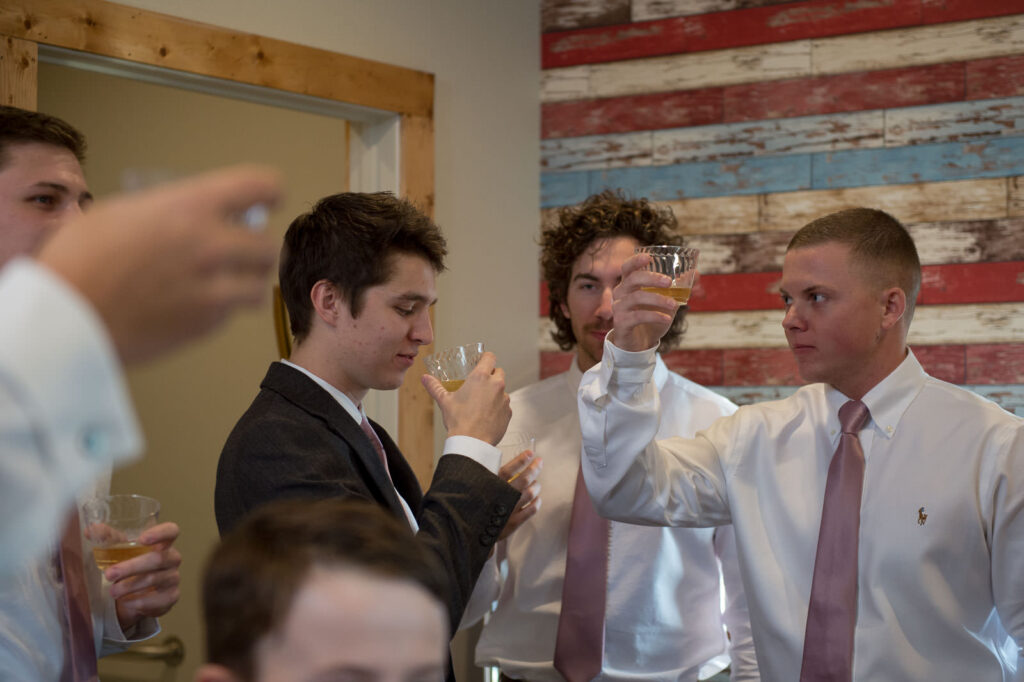 grooms taking a toast with tequila in the groom's room