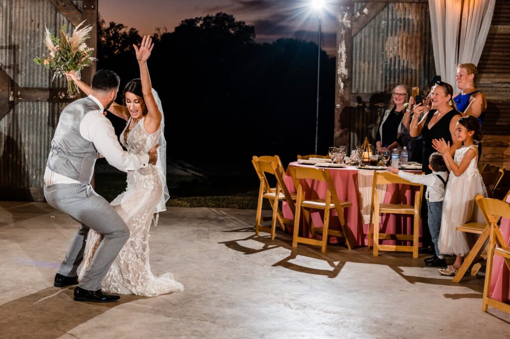 corpus christi bride and groom during grand entrance at strawberry pines wedding venue