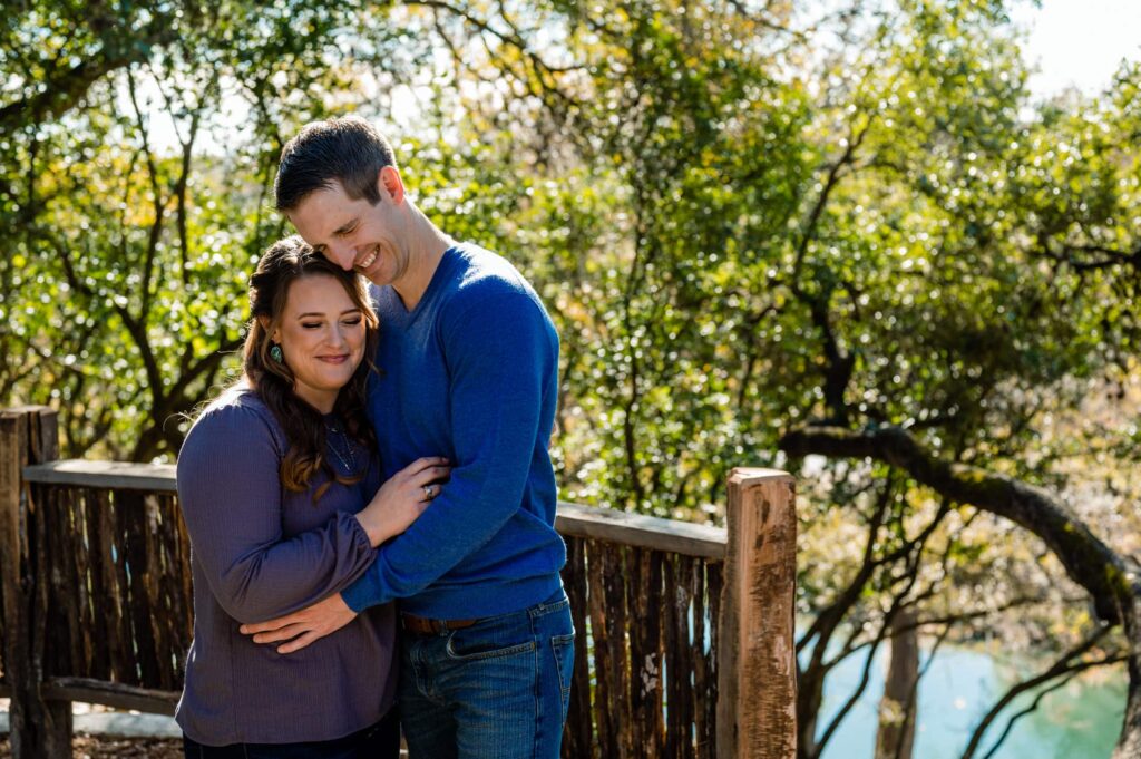 gruene historical district, texas a couple arm in arm off a back balcony of the gruene mansion inn overlooking the river by San Antonio TX Wedding Photographer Tammy Blalock