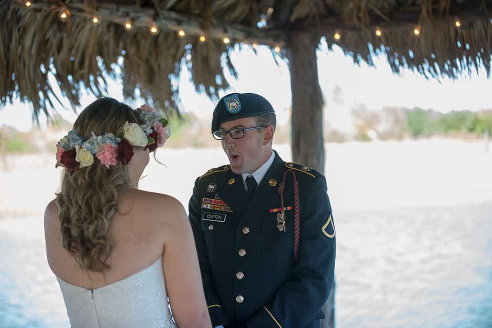 first look with military groom and his bride on the pier at strawberry pines wedding venue in poteet texas by San Antonio TX Wedding Photographer Tammy Blalock, Ata-Girl Photography Co.